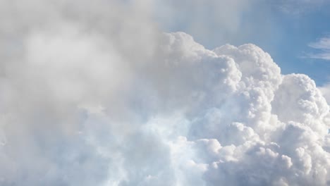 thunderstorm over the cumulonimbus clouds in the blue sky.