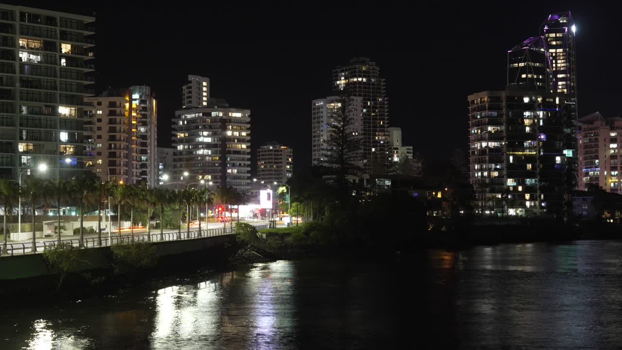 Gold Coast city Australia night time-lapse, residential buildings, traffic passing