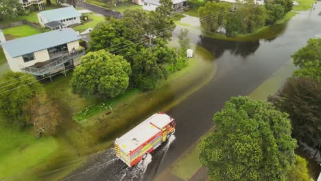 fire truck driving through flood waters after cyclone gabrielle rips through new zealand