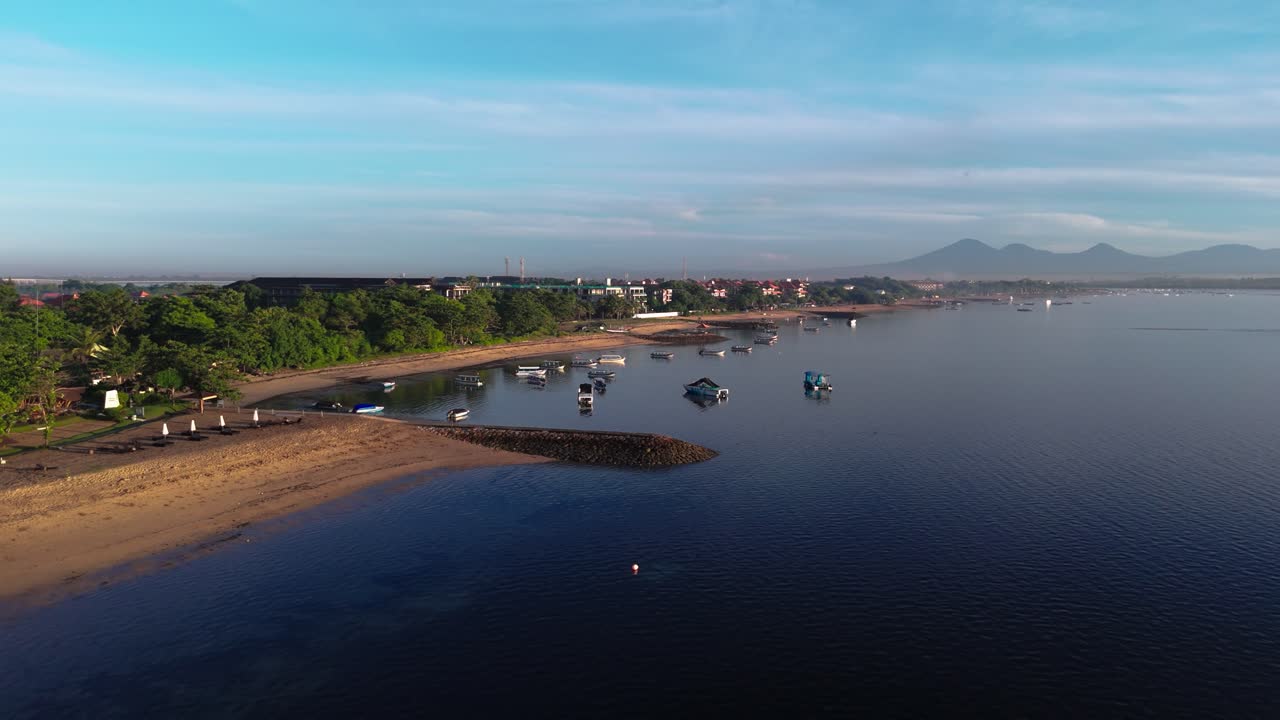Local boats and sandy coastline of Indonesia, aerial drone view