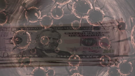 animación de células macro covid-19 flotando sobre una persona poniendo billetes de dólares estadounidenses en una mesa.