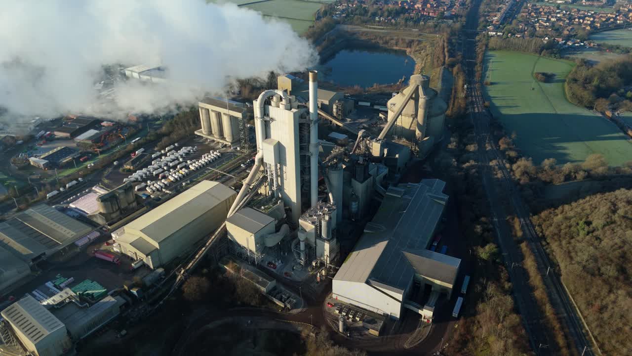 Cinematic drone orbit of the Rugby industrial landscape and heavy manufacturing cement works