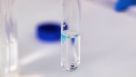 blue substance reacting in clear liquid solution