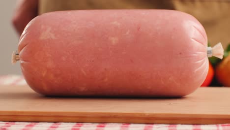 ham italian mordatella, man slices of traditional italian antipasti mortadella sausage on a wooden cutting board, close up macro of chicken or turkey jamon, fat breakfast dish.