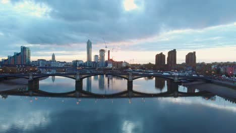 rising-falling-drone-shot-of-traffic-on-Battersea-bridge-and-Chelsea-harbour-London-at-sunset