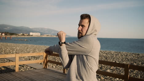 man stretching on the beach