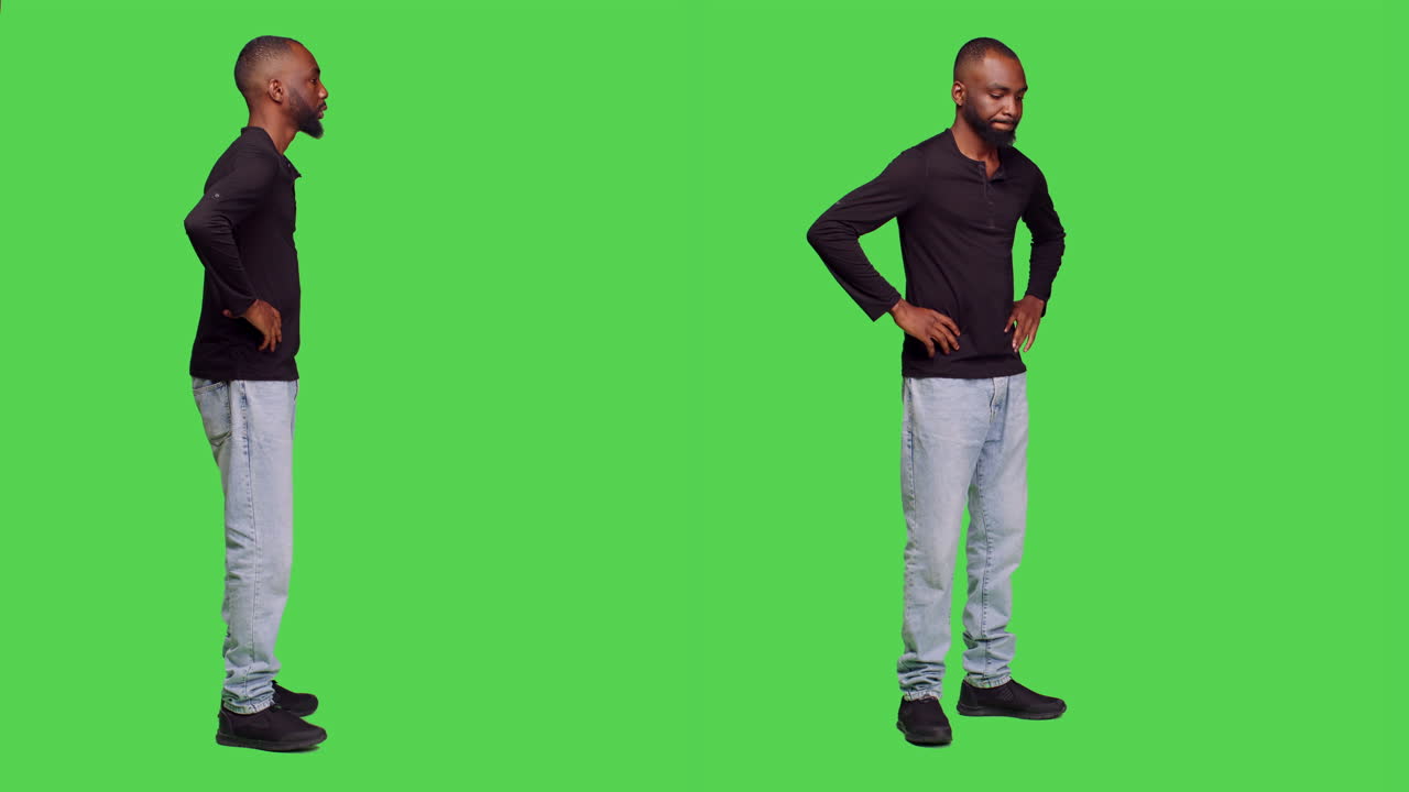 Man standing with hands on hips on green screen