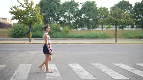 woman walking across a crosswalk