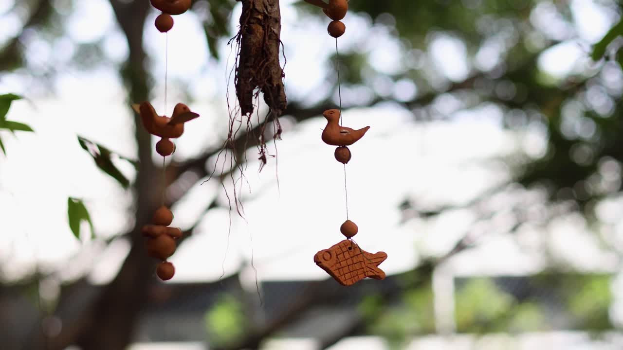Decorative fish and birds hanging from a tree