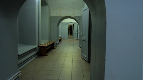 hallway in the concrete bomb shelter to hide civil people, an underground apocalypse bunker built in old coastal fortification, wide handheld shot