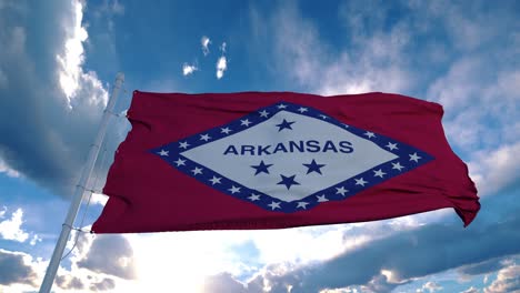 arkansas flag on a flagpole waving in the wind in the sky. state of arkansas in the united states of america
