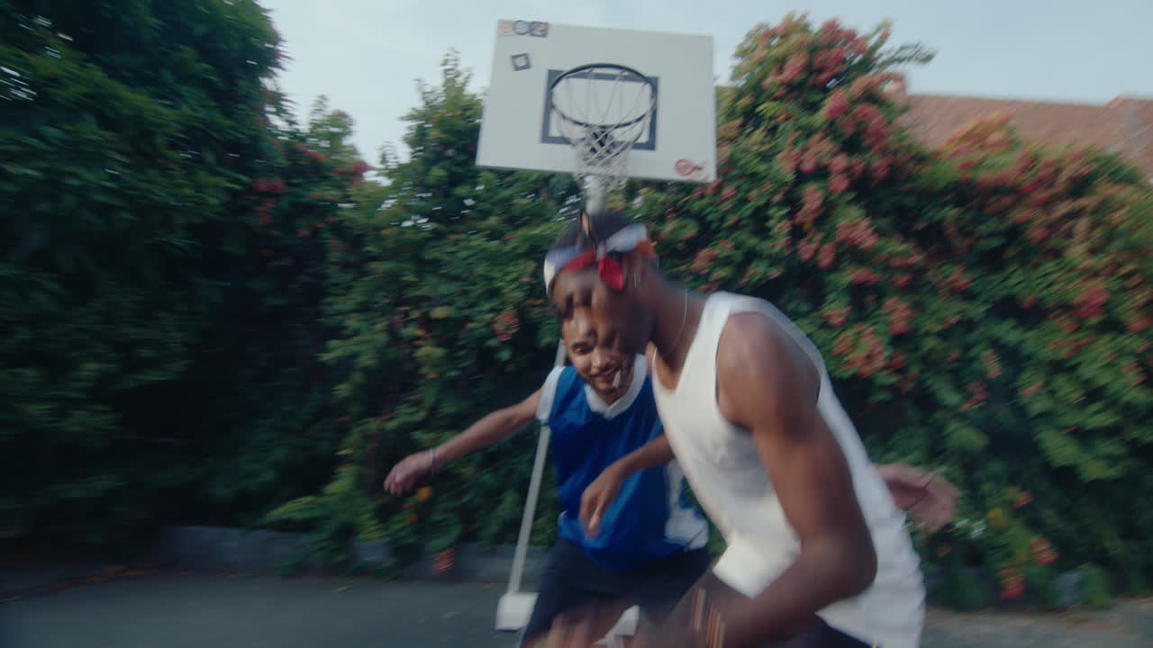 Young Black Guy Playing Basketball with Friend and Scoring