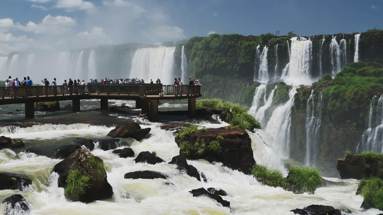 Tourist's Looking Over onto Beautiful Waterfall Scenery, Picturesque Views of Argentinian Waterfalls Hidden in Thick Green Rainforest Tourism Destination at Iguazu Falls, Brazil, South America