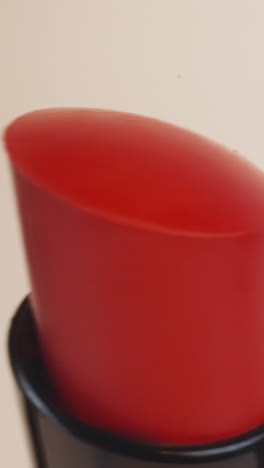 bright red lipsticks for evening makeup on beige background. presentation of high-quality cosmetic product for lips in shop for sale extreme closeup
