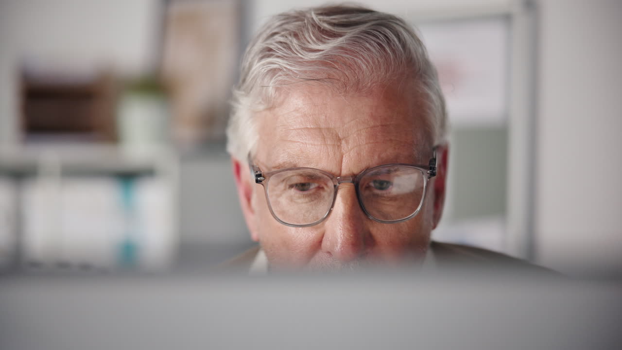 Close-up of Senior Man Working on Computer