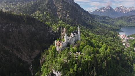 aerial circling shot of white castle in middle of green mountain forest, lake in background, beautiful scenery