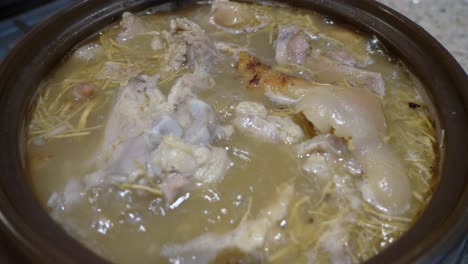 slow cooking ginseng pork bone soup boiling in clay pot zoom