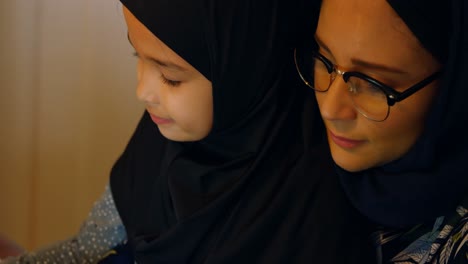 woman using laptop while daughter doing her homework 4k