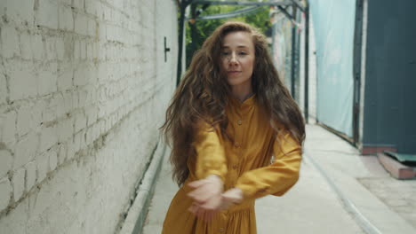 woman dancing in a city alley
