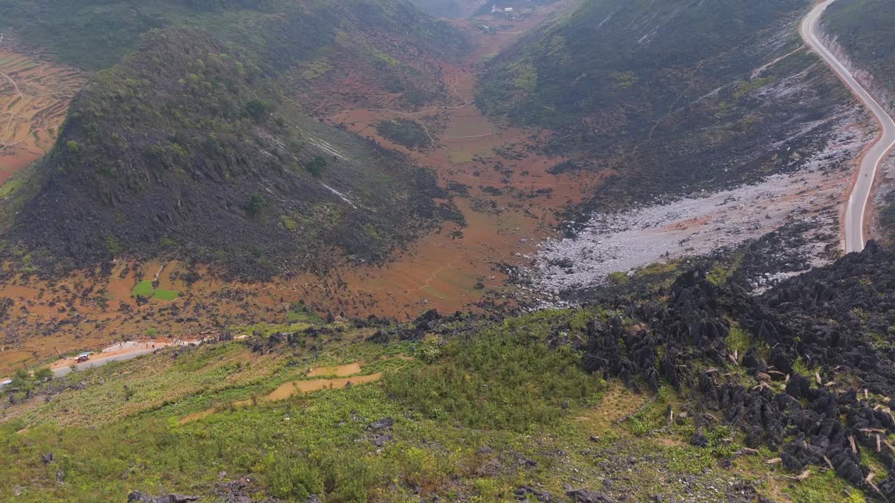 A stunning aerial perspective of Ha Giang's roads winding up the mountainside, offering breathtaking vistas.