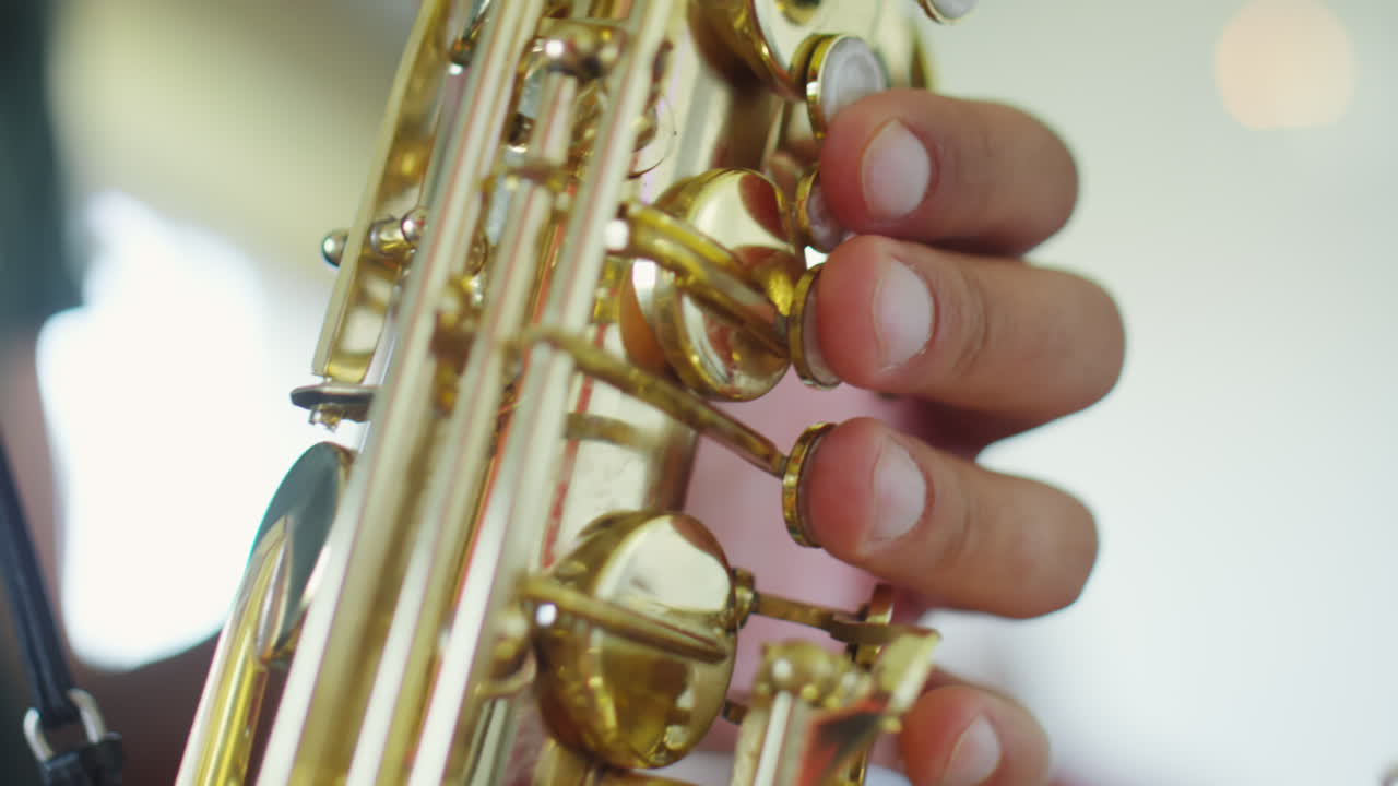 Close-up of a hand playing a saxophone