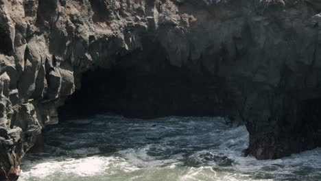 a rock cave washed by sea