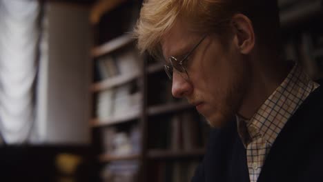 man reading in a library