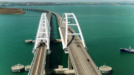 aerial view of a modern arch bridge over a waterway