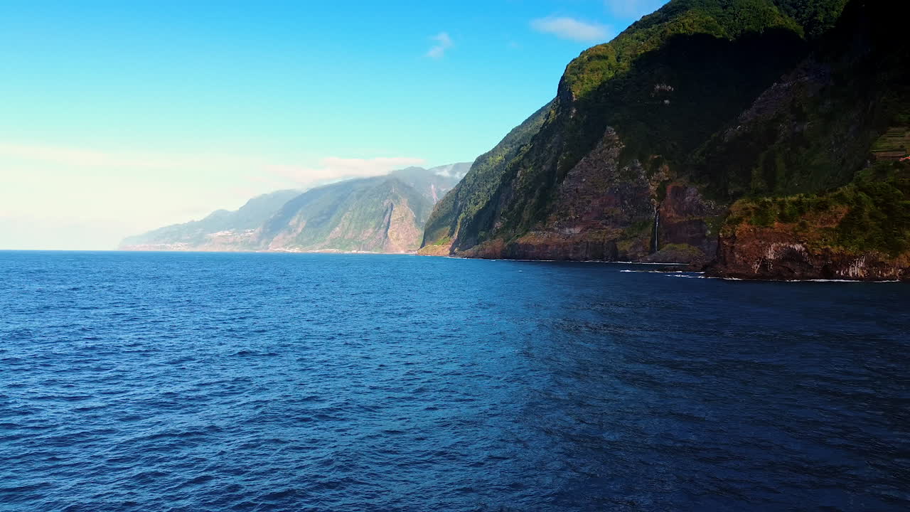 Beautiful ragged blue waterscape of the North Atlantic Ocean at the picturesque rocks. Amazing mountains on the coast of the Madeira Islands, Portugal.