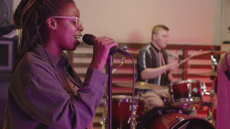 female vocalist singing during rehearsal in recording studio