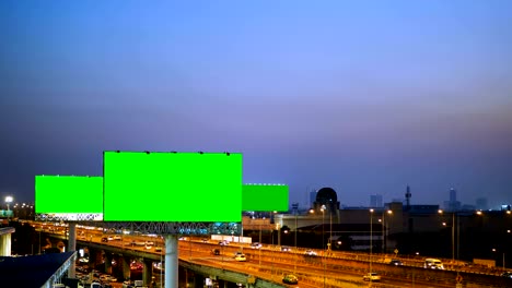 green screen of advertising billboard on expressway during the twilight with city background in bangkok, thailand.