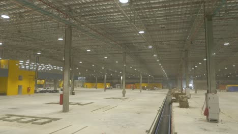 a view from the inside of a hangar, closed building structure to hold aircraft or spacecraft for protection from the weather, direct sunlight and for their repair, manufacture storage