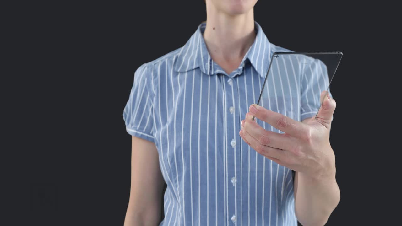 Woman holding clear panel, sweeping finger, activating green icons, showing energy finance concepts
