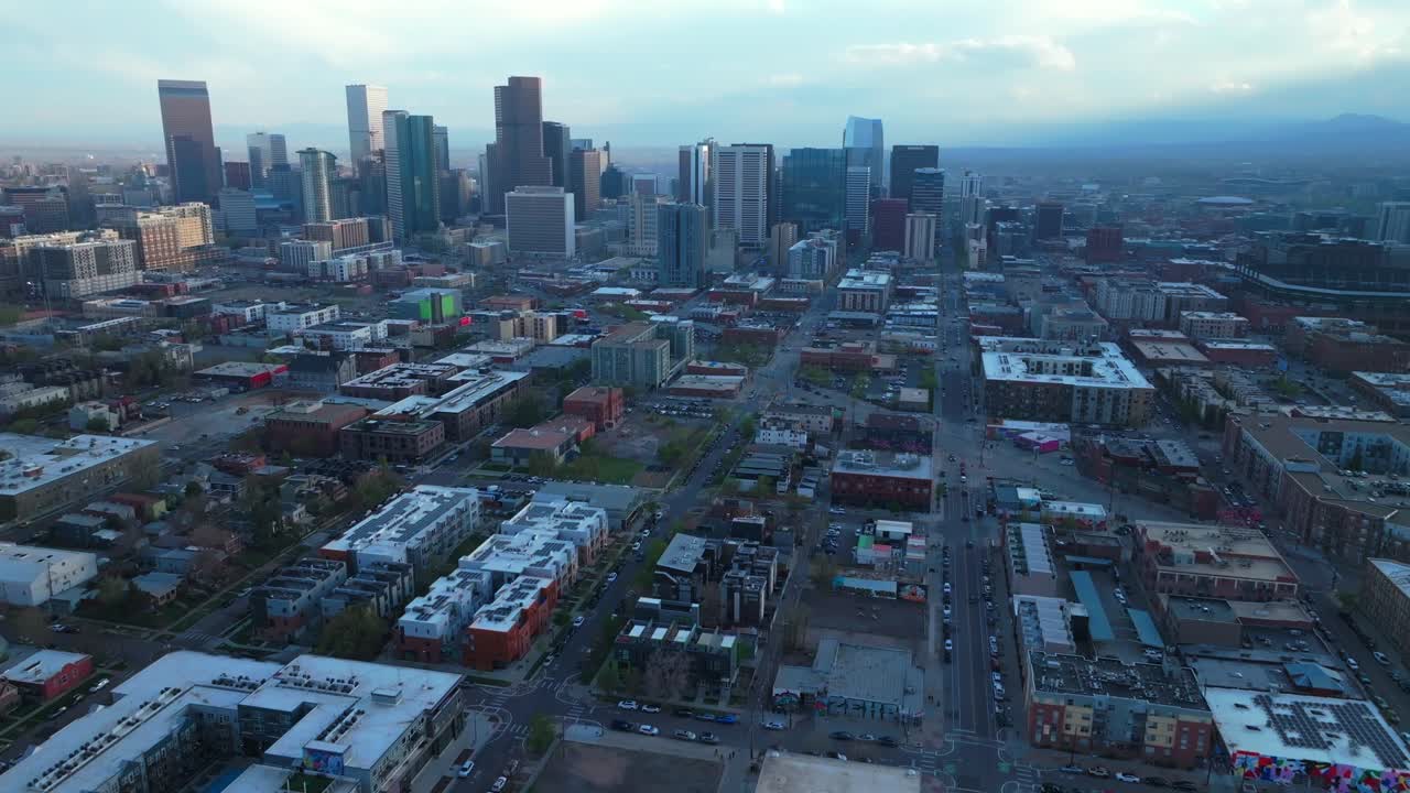 Rhino Downtown Denver cityscape city tall skyscraper buildings aerial drone Colorado spring summer afternoon sunset mountains range landscape stormy clouds sunny panorama forward pan up motion