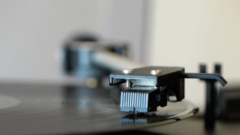 old turntable arm going down on vinyl record