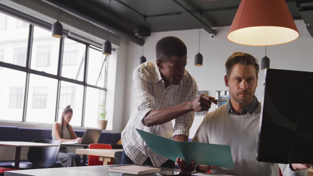 Happy diverse business people discussing work during meeting at office