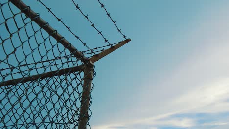 The-Scenery-of-Wired-Fence-With-Barbed-Wire-And-Mesh-Steel-Wall-During-Rainy-Season---Close-Up-Shot