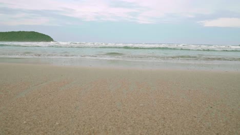 Ocean-waves-breaking-into-the-shore-on-the-beach-in-Phuket,-Thailand