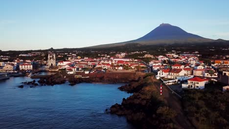 aerial landscape shot of madalena town and the coast in pico island at sunset