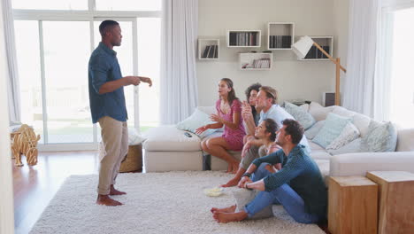 Group-Of-Friends-At-Home-Having-Fun-Playing-Charades-Together