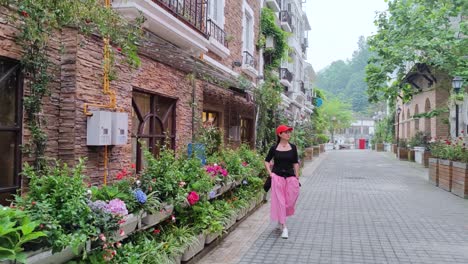 an asian woman is walking down a side street