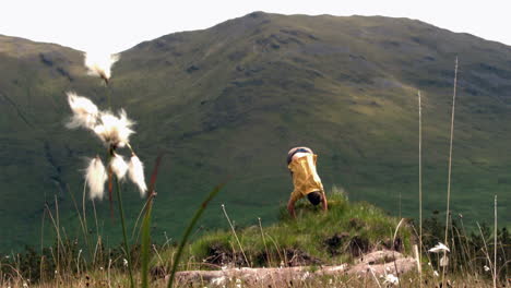 Man-tumbling-down-a-hill-in-the-countryside