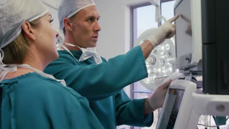 male surgeon interacting with a colleague in operation room