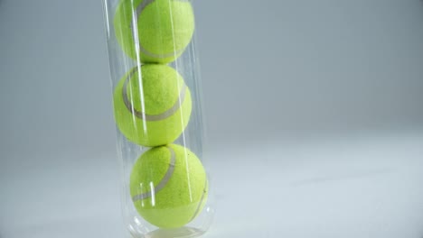 tubo de pelotas de tenis contra un fondo blanco 4k