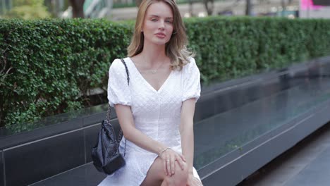 woman sitting outdoors in city