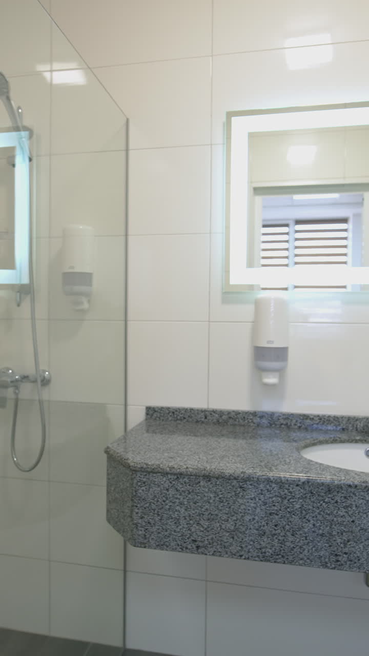 Interior of light modern bathroom. Front view of bathroom interior with shower