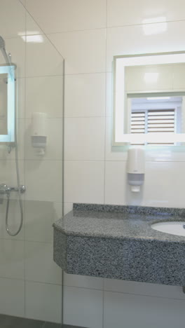 interior of light modern bathroom. front view of bathroom interior with shower