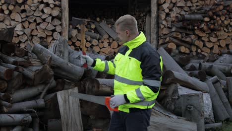 exhausted from work lumberjack. man woodcutter. sawn logs, firewood background. wood harvesting