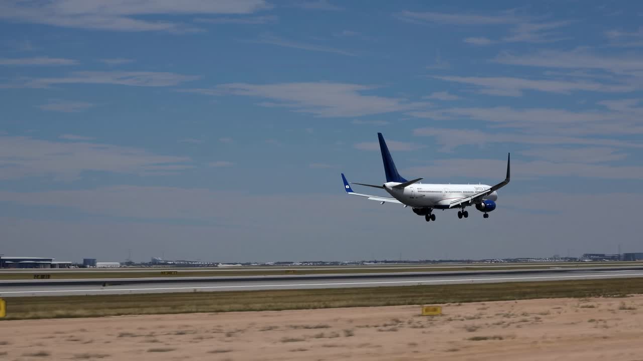Low-angle video capture of a plane landing on a runway, showcasing a dynamic and realistic