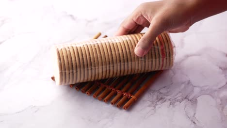 hand holding a package of stacked cookies